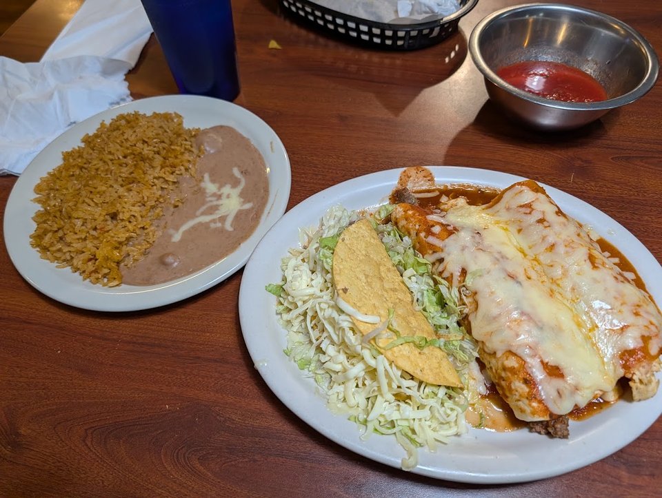 Colorful Mexican restaurant tables with plates ready.